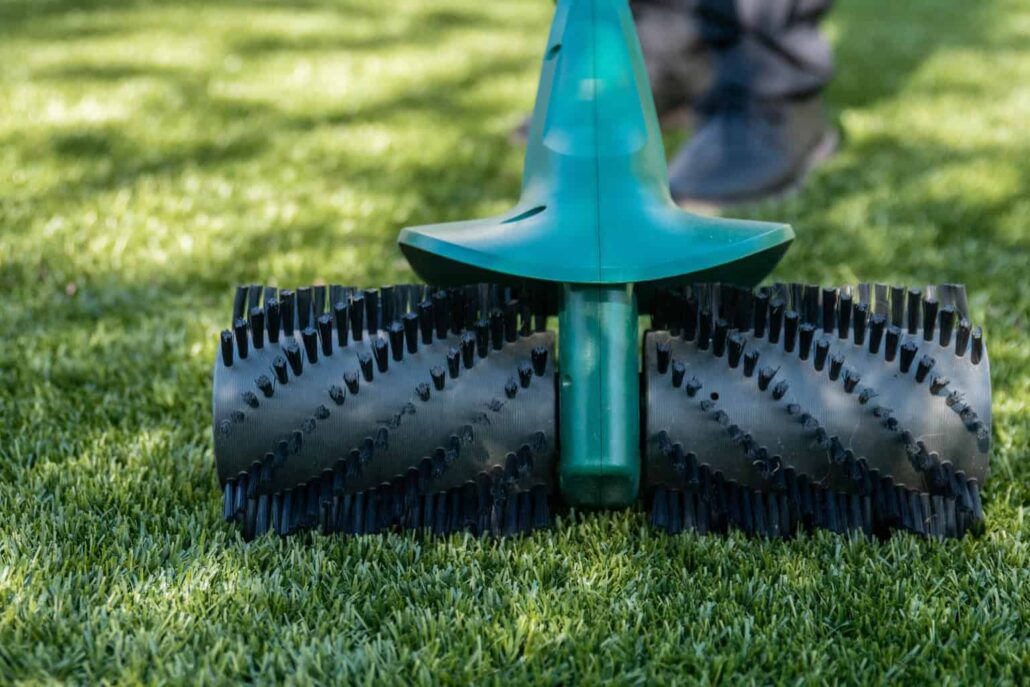 "Close-up of the TurFresh power broom on artificial grass, showcasing its eco-friendly, pet-safe design that effectively removes debris and eliminates odors from turf surfaces."