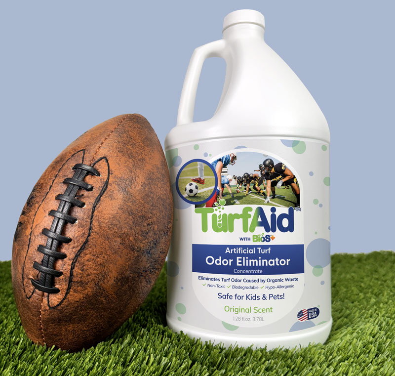 TurfAid Artificial Turf Odor Eliminator by TurFresh TurfAid artificial turf odor eliminator bottle next to a football on clean synthetic grass by TurFresh