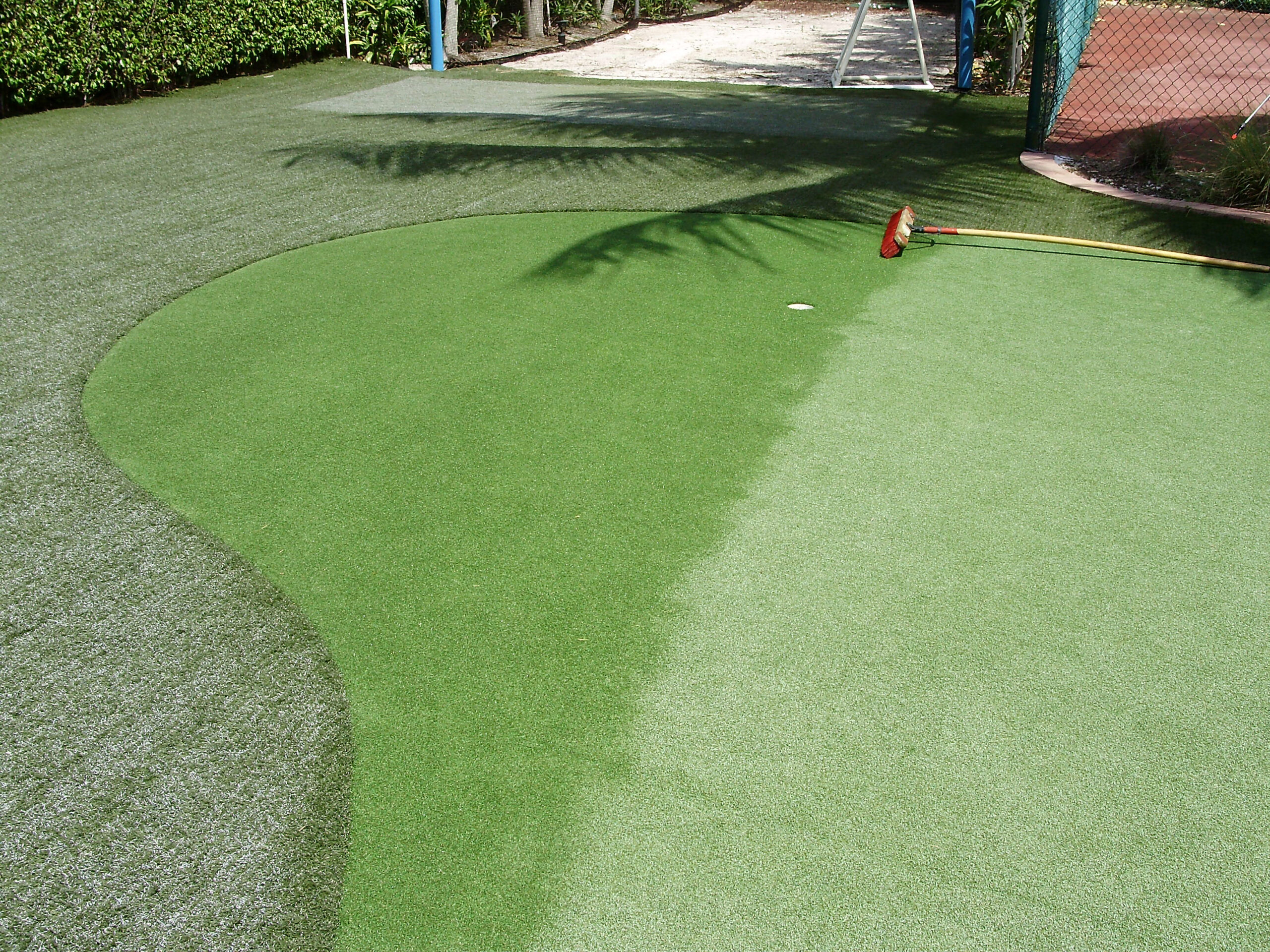 TurFresh Artificial Turf Cleaning – Restoring Putting Greens to Like-New Condition Artificial turf putting green being cleaned and restored with TurFresh maintenance brush