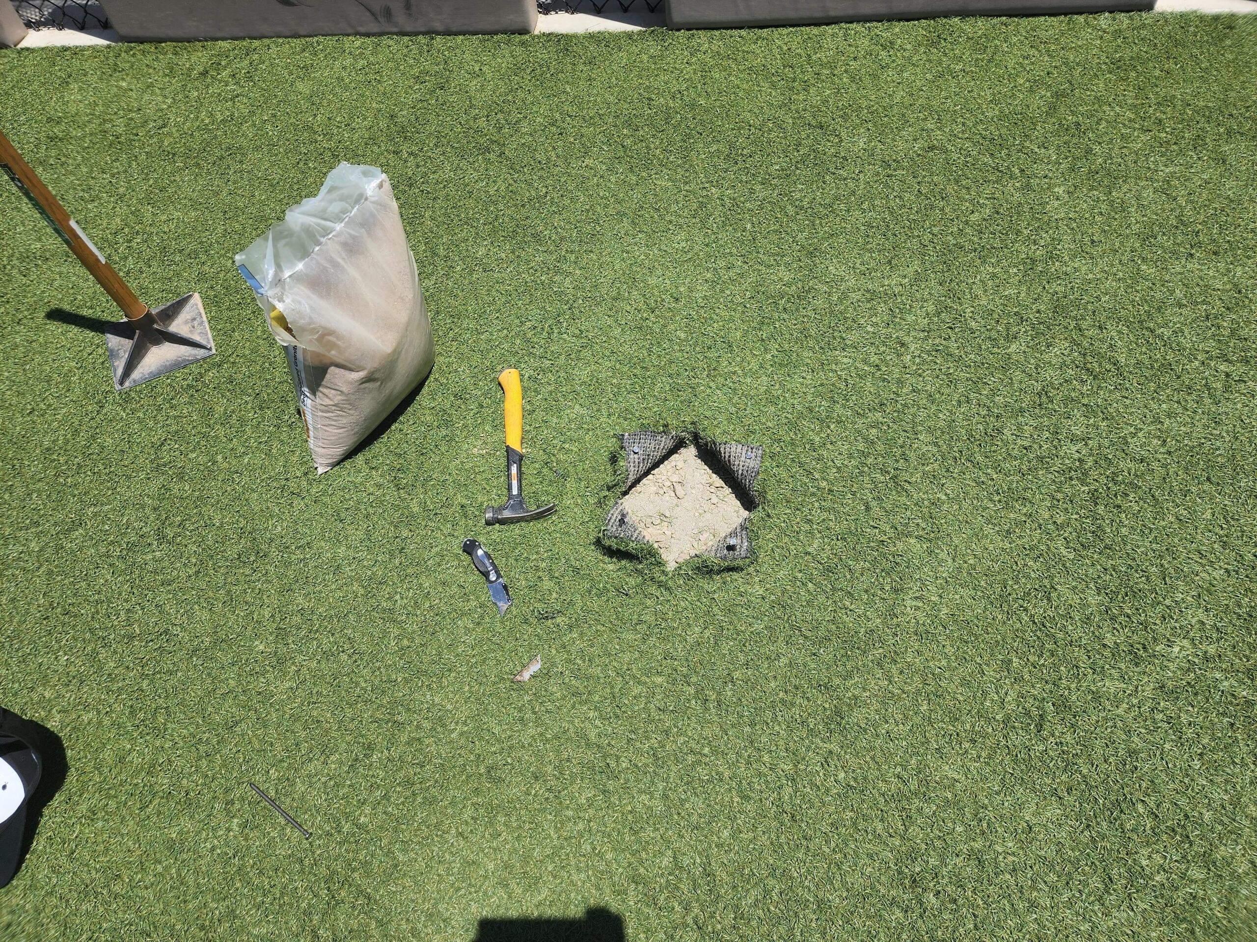 turf-cleaning-seasonal-tips-phoenix "Artificial turf maintenance with tools and infill shown during TurFresh application, a non-toxic, eco-friendly solution for eliminating odors and keeping turf fresh and safe for pets."