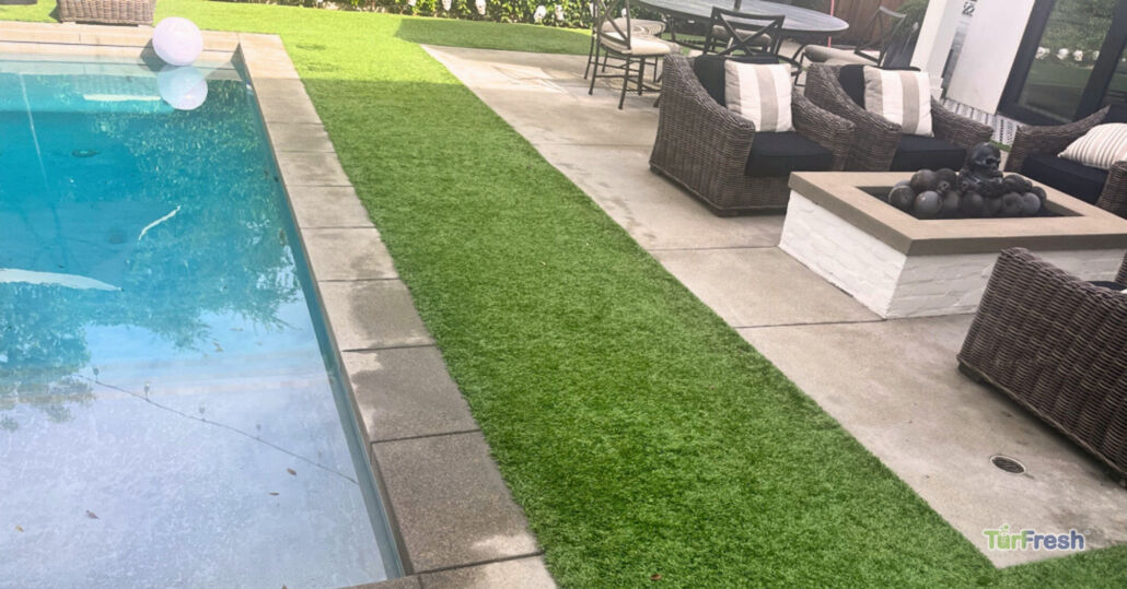 Artificial turf cleaned around swimming pool area after TurFresh professional turf cleaning service