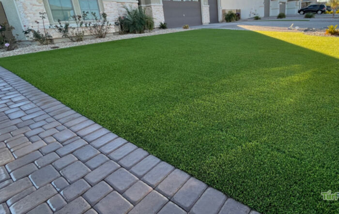 Freshly cleaned artificial turf lawn restored by TurFresh in a residential front yard
