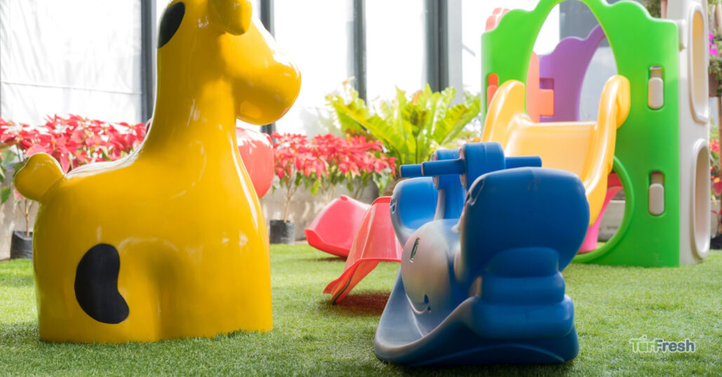 Colorful plastic playground toys on clean artificial turf after TurFresh maintenance service.