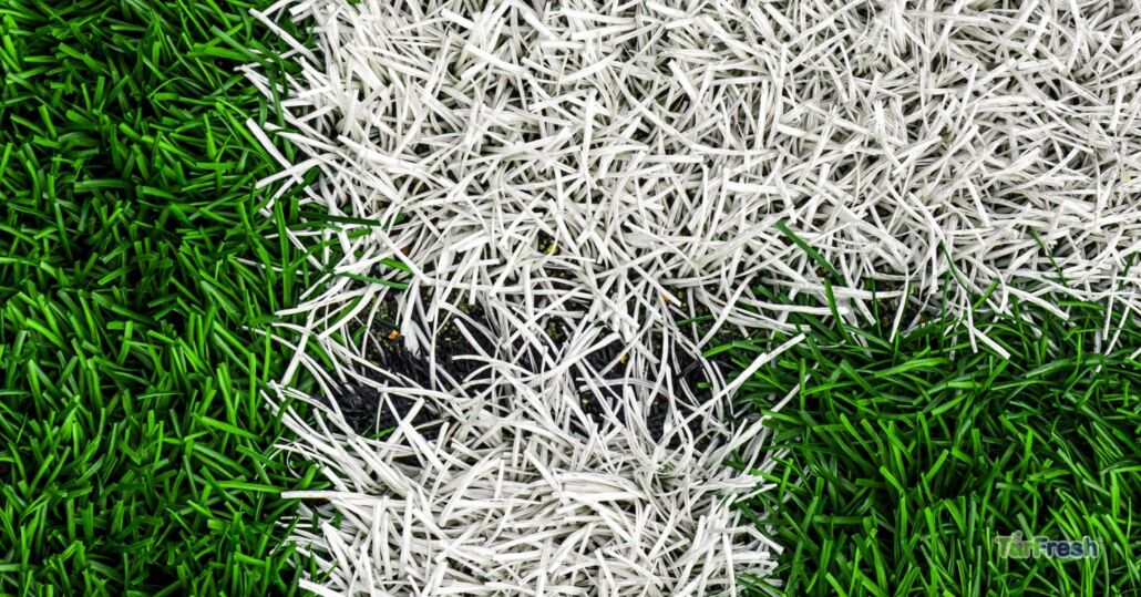 TurFresh artificial turf sports field closeup with green grass and white line fibers