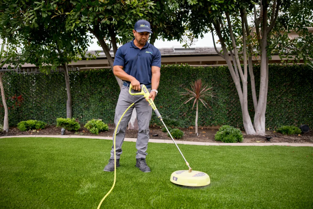 Team performing artificial turf deep-clean and maintenance service